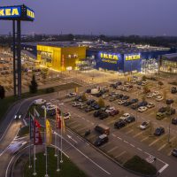 Aerial view of Ikea shopping store with parking slots, night mood. Turin, Italy - October 2022